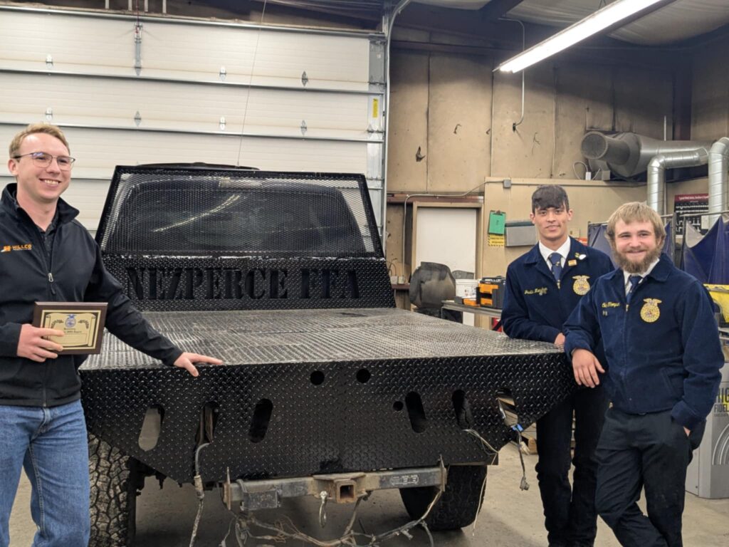 Sales Director Preston Hill with Nezperce FFA students and custom flatbed built with help from Hillco