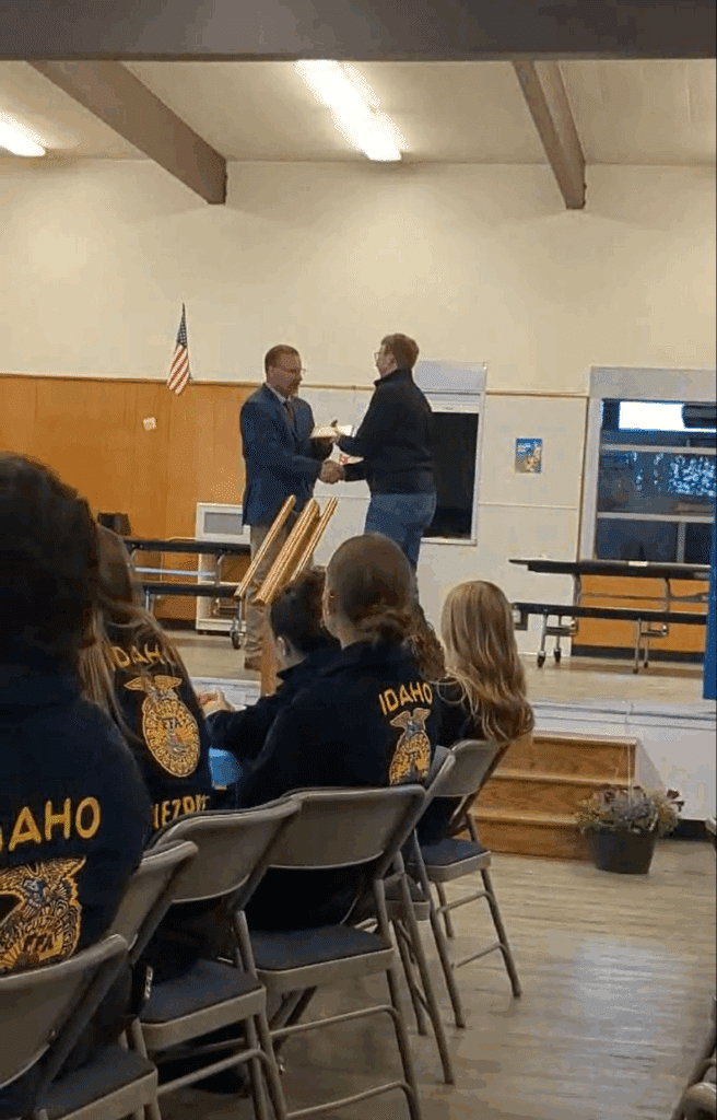 Sales Director Preston Hill accepts award for Hillco Technologies at Nezperce ID 2025 FFA Banquet